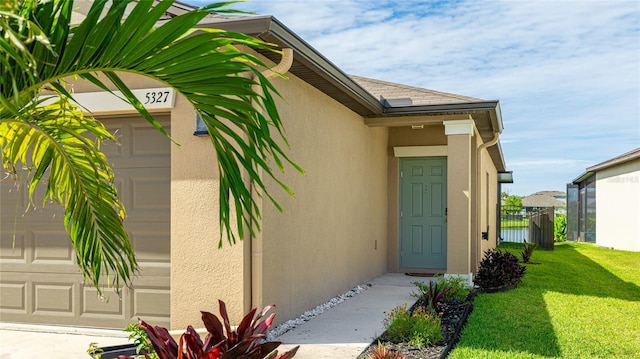5327 Olano St, Palmetto, FL 34221 - view of exterior entry with an attached garage and stucco siding