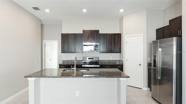 5327 Olano St, Palmetto, FL 34221 - kitchen with stainless steel appliances, dark stone counters, dark brown cabinets, and recessed lighting