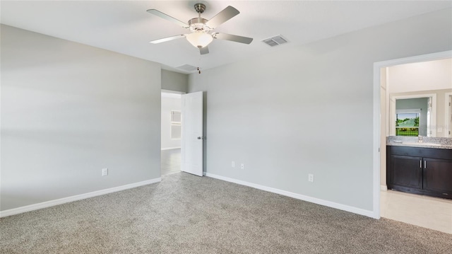 5327 Olano St, Palmetto, FL 34221 - unfurnished bedroom with light carpet, ensuite bathroom, and a ceiling fan