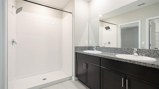 5327 Olano St, Palmetto, FL 34221 - bathroom with double vanity, a tile shower, and tile patterned floors