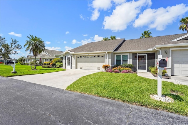 2417 Fairway Oaks Dr Unit 22, Palmetto, FL 34221 - ranch-style house featuring a front lawn, a garage, stucco siding, driveway, and a shingled roof