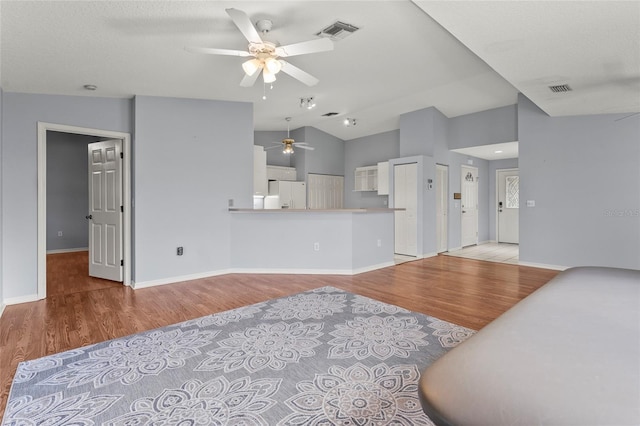 2417 Fairway Oaks Dr Unit 22, Palmetto, FL 34221 - living area featuring a ceiling fan, light wood finished floors, and vaulted ceiling