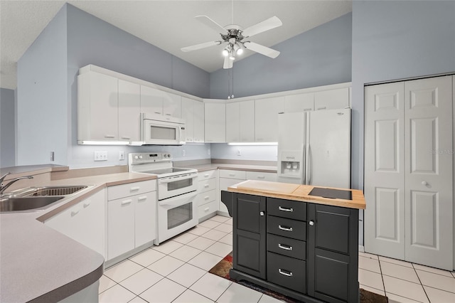 2417 Fairway Oaks Dr Unit 22, Palmetto, FL 34221 - kitchen featuring white appliances, white cabinetry, dark cabinetry, a ceiling fan, and light tile patterned flooring