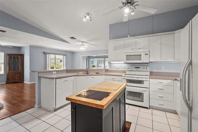 2417 Fairway Oaks Dr Unit 22, Palmetto, FL 34221 - kitchen with white appliances, ceiling fan, butcher block counters, a peninsula, and lofted ceiling
