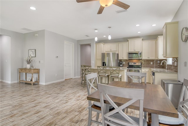11625 Renaissance Blvd, Venice, FL 34293 - dining room with ceiling fan, light wood finished floors, and recessed lighting