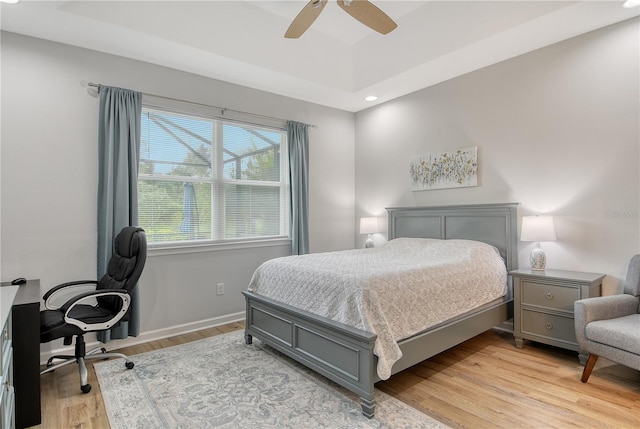 11625 Renaissance Blvd, Venice, FL 34293 - bedroom featuring light wood-type flooring, an office area, recessed lighting, ceiling fan, and a tray ceiling