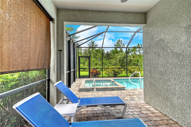 11625 Renaissance Blvd, Venice, FL 34293 - view of swimming pool featuring a patio area, glass enclosure, and a pool with connected hot tub