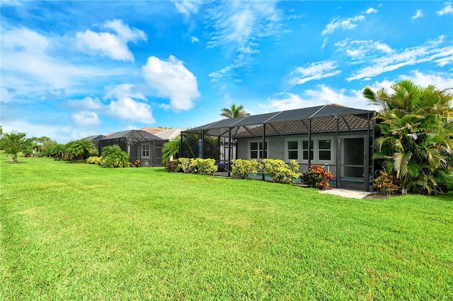 11625 Renaissance Blvd, Venice, FL 34293 - back of property with a lawn and glass enclosure