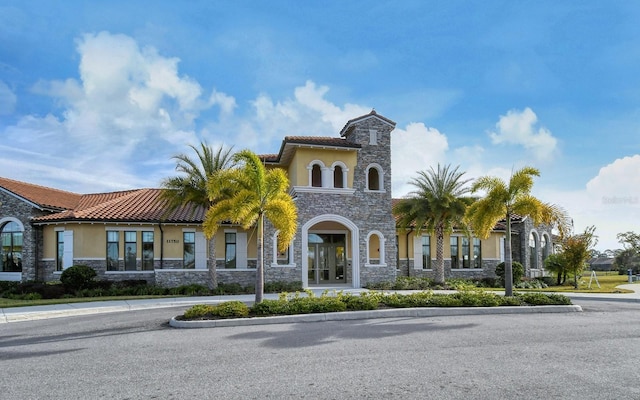 11625 Renaissance Blvd, Venice, FL 34293 - mediterranean / spanish-style home featuring stone siding, stucco siding, and a tile roof