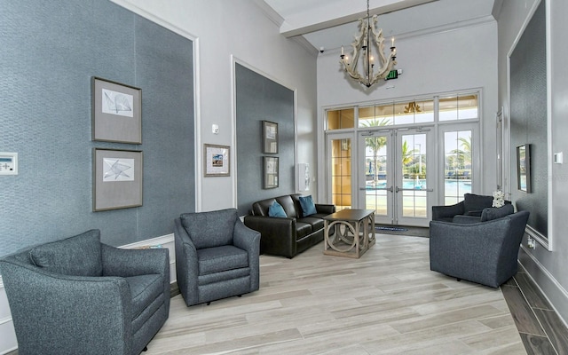 11625 Renaissance Blvd, Venice, FL 34293 - living area featuring a chandelier, a towering ceiling, french doors, and light wood finished floors