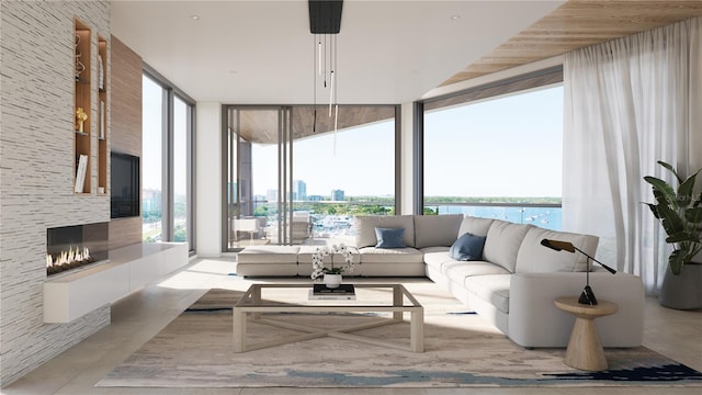 688 Golden Gate Pt Unit 202, Sarasota, FL 34236 - living area with a wall of windows, a multi sided fireplace, and a view of city