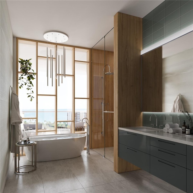 688 Golden Gate Pt Unit 202, Sarasota, FL 34236 - full bathroom featuring a soaking tub, vanity, tile patterned flooring, and a stall shower