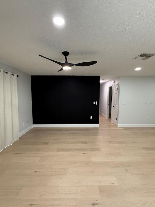 4661 Linwood St, Sarasota, FL 34232 - empty room featuring ceiling fan, light wood-type flooring, a textured ceiling, and recessed lighting