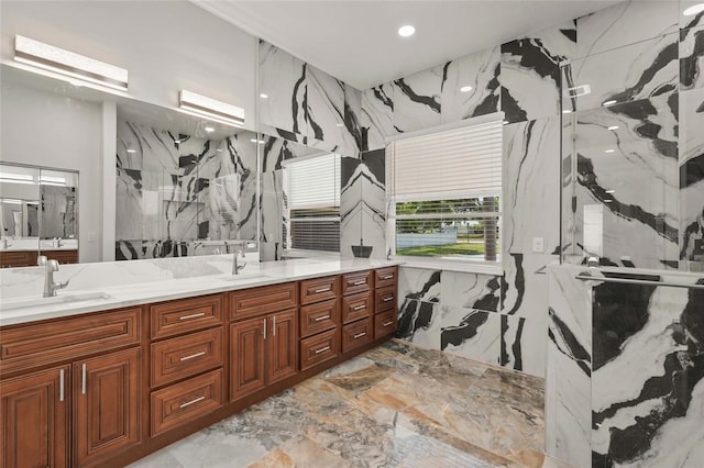 5714 38th Ave E, Bradenton, FL 34208 - bathroom featuring marble tiled floors, a marble finish shower, double vanity, recessed lighting, and stone wall