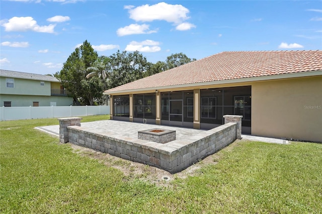 5714 38th Ave E, Bradenton, FL 34208 - back of house featuring a sunroom, a patio area, a fire pit, and a tiled roof