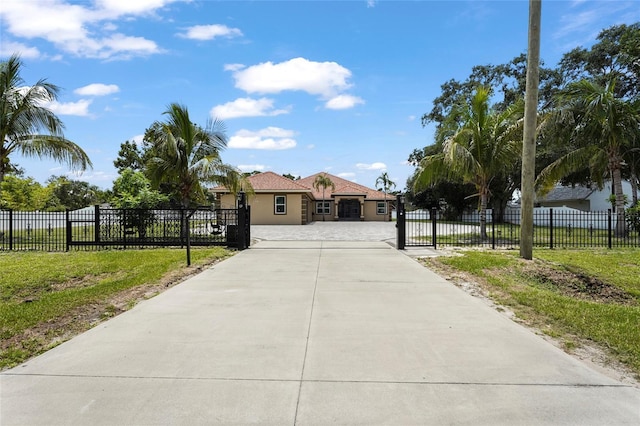 5714 38th Ave E, Bradenton, FL 34208 - mediterranean / spanish-style home with stucco siding and a gate