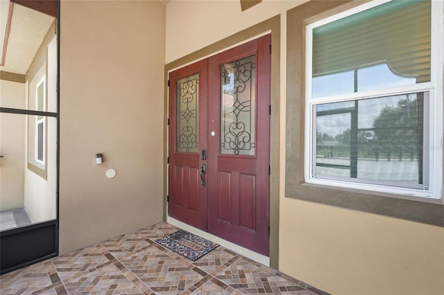 5714 38th Ave E, Bradenton, FL 34208 - view of exterior entry with stucco siding and covered porch