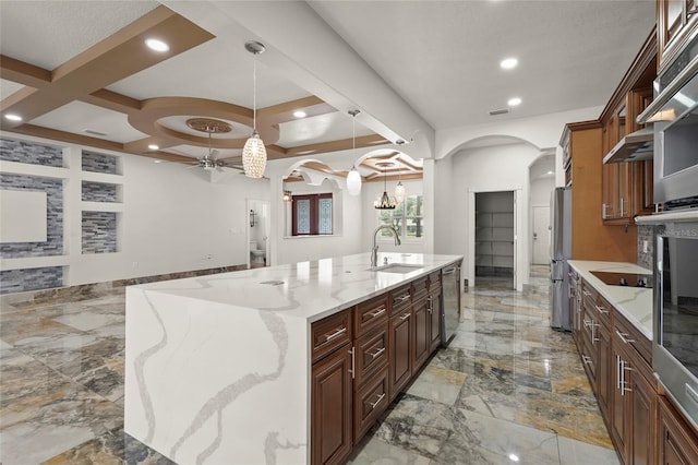 5714 38th Ave E, Bradenton, FL 34208 - kitchen featuring stainless steel appliances, arched walkways, a spacious island, coffered ceiling, and light stone countertops