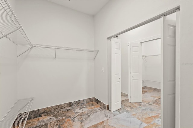 5714 38th Ave E, Bradenton, FL 34208 - walk in closet featuring marble finish floors