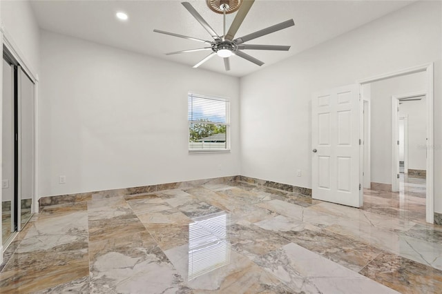 5714 38th Ave E, Bradenton, FL 34208 - unfurnished bedroom featuring marble tiled floors, recessed lighting, ceiling fan, and a closet