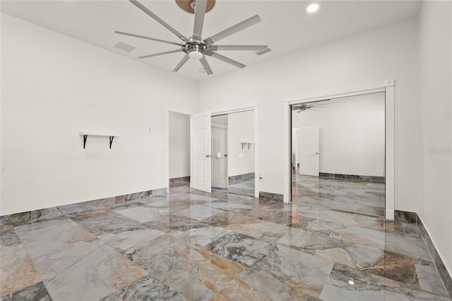 5714 38th Ave E, Bradenton, FL 34208 - unfurnished bedroom with marble tiled flooring, multiple closets, ceiling fan, and recessed lighting