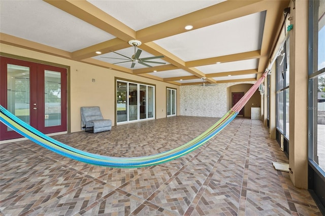 5714 38th Ave E, Bradenton, FL 34208 - unfurnished sunroom featuring french doors, coffered ceiling, beam ceiling, and arched walkways