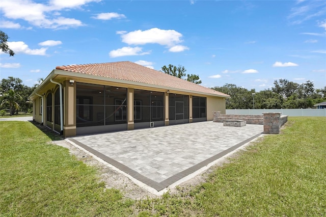 5714 38th Ave E, Bradenton, FL 34208 - rear view of property with a sunroom, an outdoor fire pit, a patio, and a tiled roof