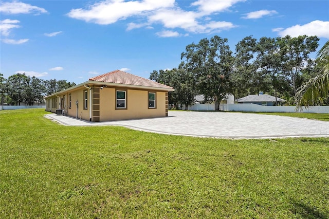 5714 38th Ave E, Bradenton, FL 34208 - rear view of house featuring stucco siding, a tile roof, and a patio