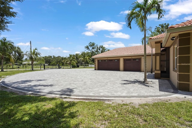 5714 38th Ave E, Bradenton, FL 34208 - view of yard featuring an attached garage and decorative driveway