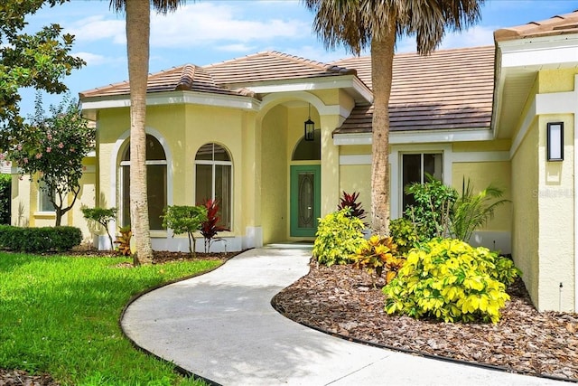 4724 White Tail Ln, Sarasota, FL 34238 - doorway to property featuring stucco siding and a tile roof