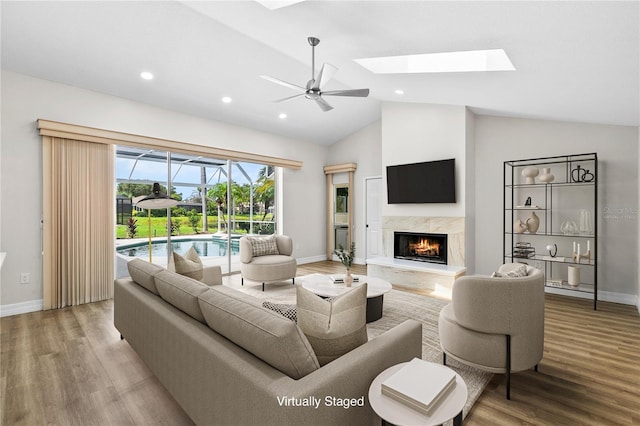 4724 White Tail Ln, Sarasota, FL 34238 - living room featuring ceiling fan, wood finished floors, a fireplace, recessed lighting, and high vaulted ceiling