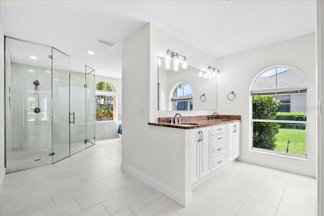 4724 White Tail Ln, Sarasota, FL 34238 - bathroom with plenty of natural light, double vanity, a stall shower, and recessed lighting