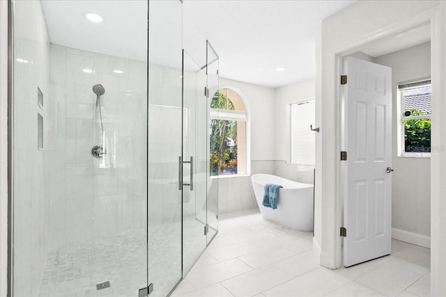 4724 White Tail Ln, Sarasota, FL 34238 - full bath with a stall shower, a soaking tub, plenty of natural light, tile patterned floors, and recessed lighting