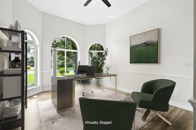 4724 White Tail Ln, Sarasota, FL 34238 - home office with a ceiling fan, wood finished floors, and a towering ceiling
