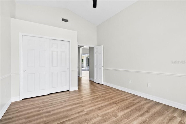 4724 White Tail Ln, Sarasota, FL 34238 - unfurnished bedroom with wood finished floors, lofted ceiling, a closet, and a ceiling fan
