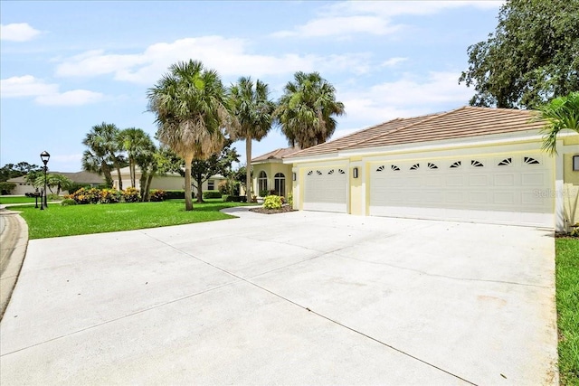 4724 White Tail Ln, Sarasota, FL 34238 - view of front facade with driveway, a garage, a front lawn, and stucco siding