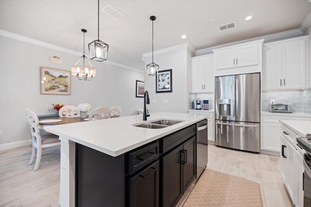 12349 Asana Ct, Venice, FL 34293 - kitchen with stainless steel appliances, crown molding, light countertops, decorative backsplash, and white cabinetry