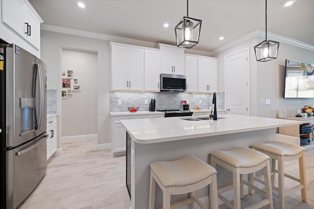 12349 Asana Ct, Venice, FL 34293 - kitchen with appliances with stainless steel finishes, ornamental molding, light countertops, backsplash, and a kitchen breakfast bar