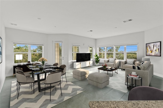 7611 34th Ave W Unit 301, Bradenton, FL 34209 - living room with plenty of natural light and light tile patterned floors