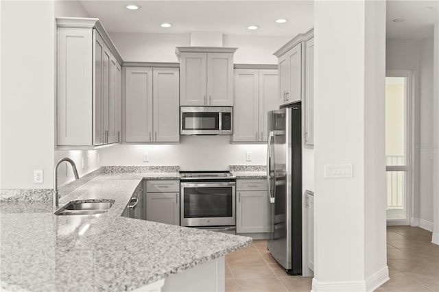 7611 34th Ave W Unit 301, Bradenton, FL 34209 - kitchen featuring appliances with stainless steel finishes, gray cabinetry, light tile patterned flooring, light stone countertops, and recessed lighting