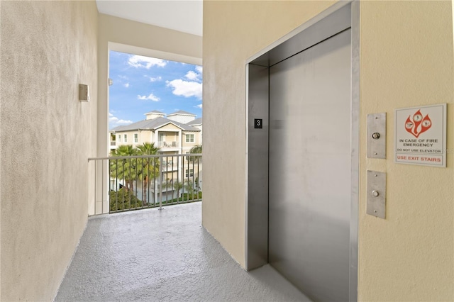 7611 34th Ave W Unit 301, Bradenton, FL 34209 - hallway featuring elevator, a textured wall, and carpet flooring