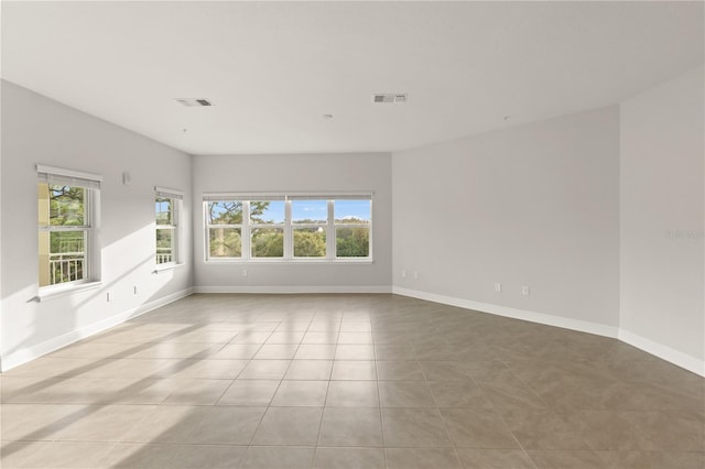 7611 34th Ave W Unit 301, Bradenton, FL 34209 - spare room featuring plenty of natural light and tile patterned floors