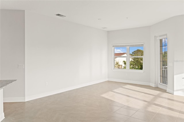 7611 34th Ave W Unit 301, Bradenton, FL 34209 - spare room featuring light tile patterned flooring and baseboards