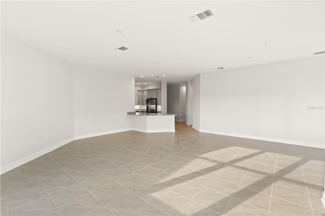 7611 34th Ave W Unit 301, Bradenton, FL 34209 - unfurnished living room featuring baseboards