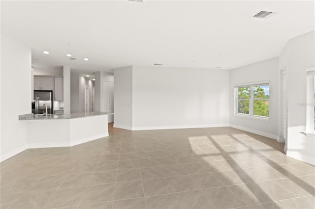7611 34th Ave W Unit 301, Bradenton, FL 34209 - unfurnished living room featuring recessed lighting and baseboards