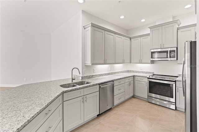 7611 34th Ave W Unit 301, Bradenton, FL 34209 - kitchen featuring appliances with stainless steel finishes, gray cabinetry, light tile patterned floors, light stone countertops, and recessed lighting