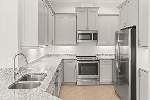 7611 34th Ave W Unit 301, Bradenton, FL 34209 - kitchen with stainless steel appliances, light tile patterned flooring, light stone counters, and gray cabinets