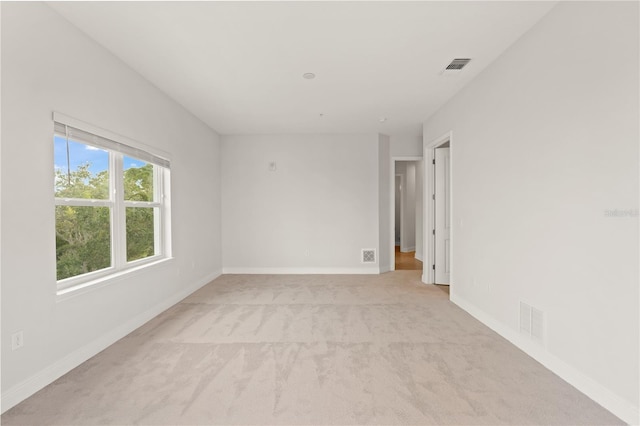 7611 34th Ave W Unit 301, Bradenton, FL 34209 - spare room featuring light carpet and baseboards
