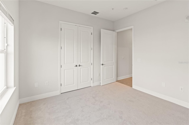 7611 34th Ave W Unit 301, Bradenton, FL 34209 - unfurnished bedroom featuring carpet floors and a closet