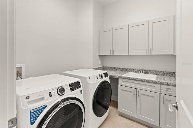7611 34th Ave W Unit 301, Bradenton, FL 34209 - laundry area with washer and clothes dryer, cabinet space, and light tile patterned floors